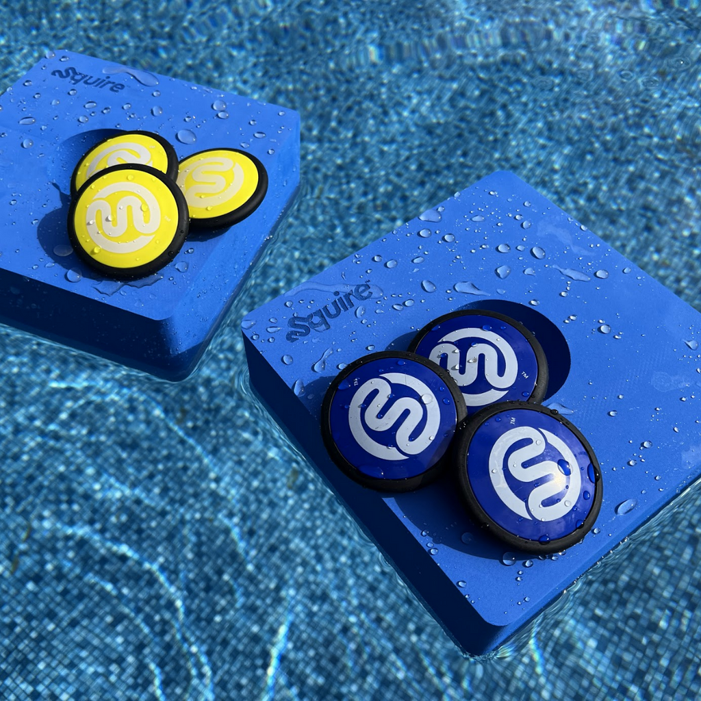 2 original Squire above-ground pool game targets floating in pool with 6 skip discs