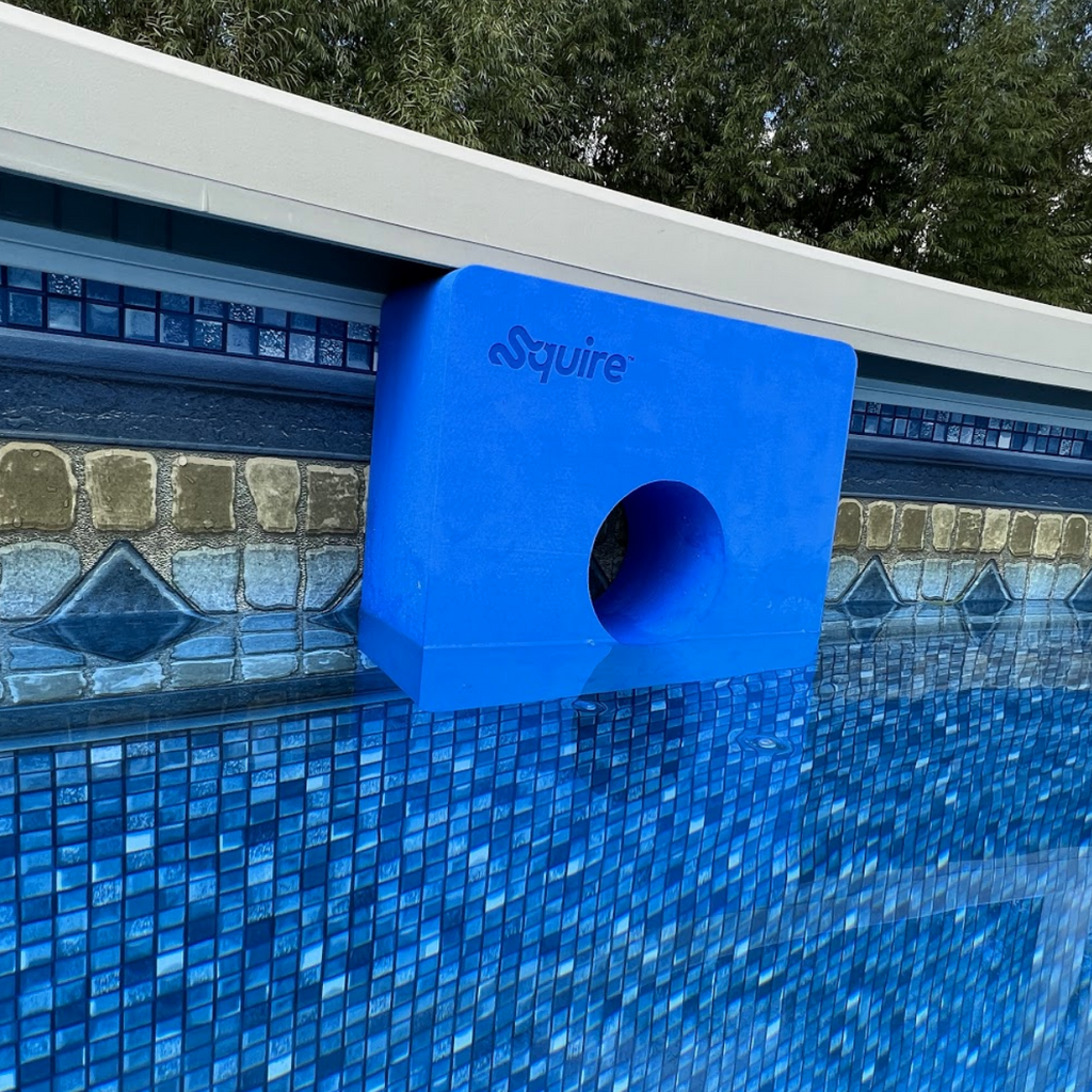 One blue Squire target held in place by the top rail or ledge of above-ground swimming pool